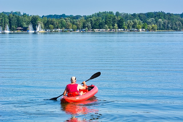 Person kayaking on clear lake